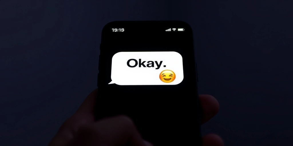 A text message saying Okay with a smiling emoji on a phone screen A text message saying Okay with a smiling emoji on a phone screen